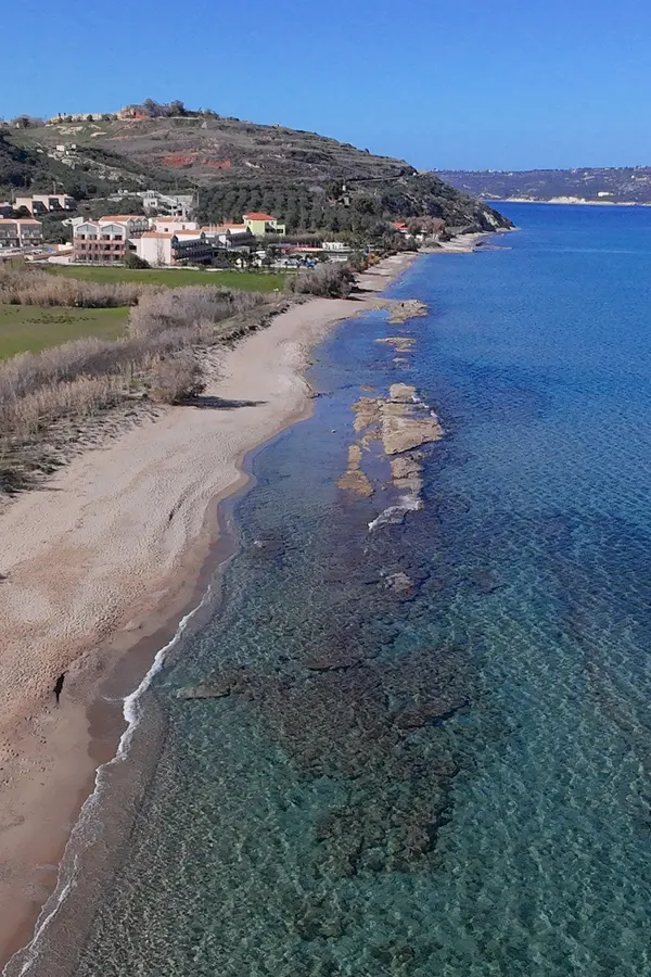 Wide stretch of white sand and brilliant turquoise waters at Kiani Akti Beach, Crete.